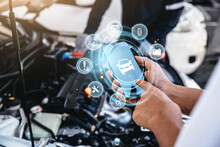Mechanic using smart phone checking up on car engines parts for fixing and repair, Smart service diagnostics software concept.