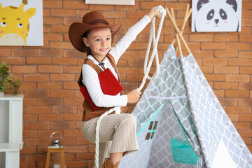 Poster - Cute little cowgirl with rope and adventure book at home