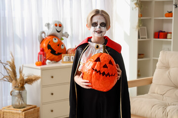 Poster - Little boy with pumpkin celebrating Halloween at home