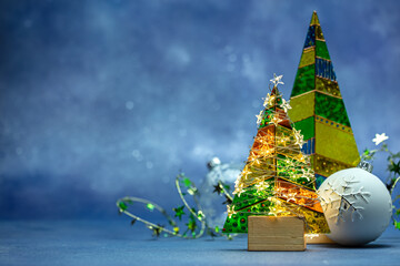 Sticker - new year decorations. christmas tree with glowing holiday lights and firtree glass balls. blue background.