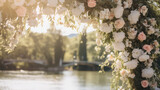 Fototapeta Desenie - The image shows a beautiful arrangement of pink and white roses in a floral arch, with a serene lake and a clear blue sky in the background.