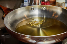 Olive oil in frying pan with chia grains