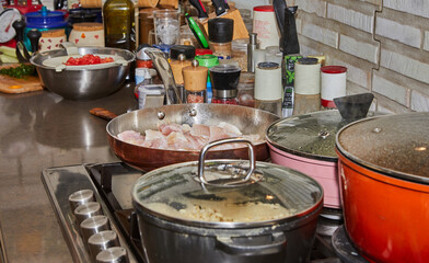 Wall Mural - Pots with cooking food in the kitchen on gas stove