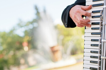 Accordion. Keys. Male hand on the accordion.