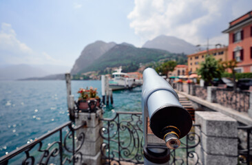 Wall Mural - Coin Operated Spyglass viewer next to the waterside promenade looking out to the bay of Como Lake, Italy