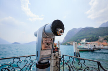 Wall Mural - Coin Operated Spyglass viewer next to the waterside promenade looking out to the bay of Como Lake, Italy