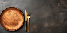 Top View Of An Empty Plate With Cutlery On A Dark Concrete Background