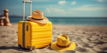 Baggage Travel. Yellow Suitcase With Travel Accessories Such As Sunglasses, Hat And Camera On Sea Beach Background.