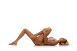 © master1305 - Stretching. Slim female body. Pretty young girl with tanned body lying in underwear against white studio background. Concept of natural beauty, body and skin care, sport, wellness. Copy space for ad