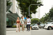 © DragonImages - Group of young people crossing road in city downtown