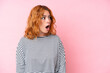 © luismolinero - Young caucasian woman isolated on pink background doing surprise gesture while looking to the side