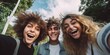 Cheerful international friends teenagers taking selfie while walking in summer park, happy memories concept