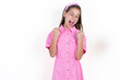 © Roquillo - Ecstatic Beautiful kid girl wearing pink dress shout loud yeah fist up raise win lottery