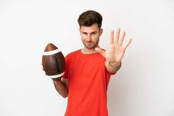 Wall Mural - Young caucasian man playing rugby isolated on white background counting five with fingers