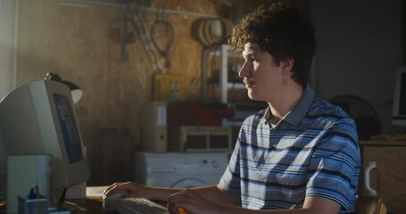 Fototapete - Caucasian Male Software Engineer Programming On Old Desktop Computer In Retro Garage. Enthusiast Browsing Early Internet Forums, Coding Applications In Nineties. Nostalgia Concept. Zoom Out Shot.