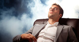 Fototapeta  - 
Hombre de negocios en traje durmiendo plácidamente en su oficina corporativa, con expresión serena, en un sofá de cuero y fondo de humo.