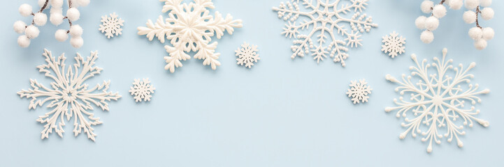 Wall Mural - White snowflakes and rowan branches on a blue background, Christmas background, Merry Christmas and Happy New Year banner, top view, copy space