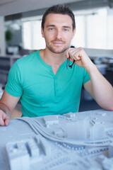 Poster - Architecture model, portrait and professional man planning real estate development, project or buildings design. Startup, developer and architect working on property, construction or infrastructure