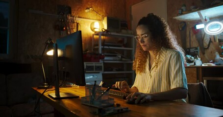 Poster - Hispanic Female Software Engineer Programming on Desktop Computer In Retro Garage Late At Night. Ambitious Woman Starting Technological Startup Company. Coding Innovative Online Service At Home.
