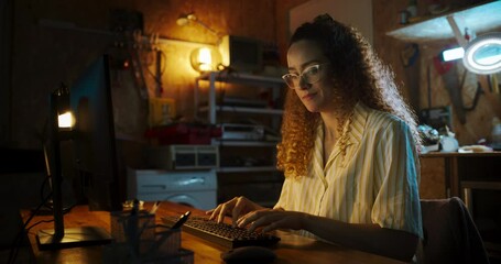 Poster - Portrait of Hispanic Female Software Engineer Programming on Desktop Computer In Retro Garage Late At Night. Ambitious Woman Starting Tech Startup Company. Coding Innovative Online Service At Home.