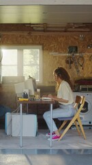 Leinwandbilder - Vertical Screen: Hispanic Female Software Engineer Programming On Old Desktop Computer In Retro Garage With Random Appliances. Woman Working On Innovative Online Service Startup Company In Nineties.