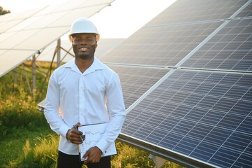 Photovoltaic Green Energy Technology. Worker At Solar Panel Plant