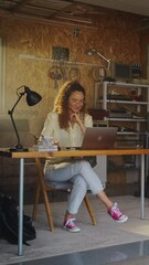 Leinwandbilder - Vertical Screen: Hispanic Female Programmer Coding On Laptop Computer In Garage At Home. Young Woman Working On Software As A Service Startup For Business. Digital Entrepreneur Starting Tech Company.