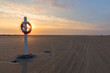 Life buoy at the beach of Fanø in sunrise