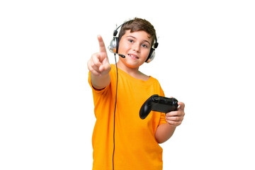 Wall Mural - Little caucasian kid playing with a video game controller over isolated chroma key background showing and lifting a finger