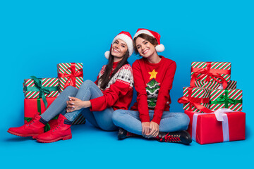 Sticker - Full length photo of sweet adorable ladies santa helpers dressed print sweaters preparing xmas presents isolated blue color background