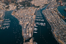 Aerial View Of Many Sailboat Docked At The Harbour In La Valletta Downtown At Sunset In Malta.