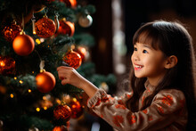 Happy Korean Girl Decorates Christmas Tree