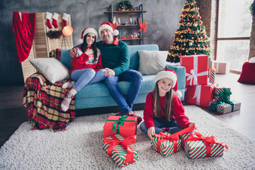 Sticker - Full body portrait of idyllic peaceful family parents sit comfort couch daughter unpack newyear giftbox apartment indoors