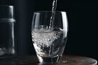 Close-up of pouring purified water into a glass. Refreshing natural water for hydration. Generative AI