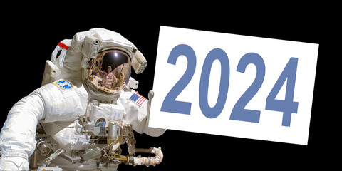 Wall Mural - astronaut in space holding a 2024 white board - elements of this image are provided by nasa