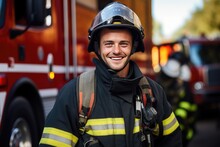 Photograph Of A Cheerful Firefighter Wearing A Gas Mask And Helmet Standing Beside A Fire Engine.