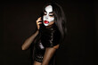© marcink3333 - Sexy woman in a Halloween makeup on black background.