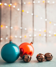 Shiny Red And Blue Baubles With Sleigh Bells Close Up On A Table With Christmas Lights In The Background 3d Render