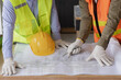 © SOMKID - Two engineer working project planning in congratulations site work.