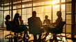 © Malambo/Peopleimages - AI - Silhouette of group of business people having a meeting or brainstorming in a boardroom