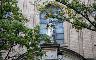 Church in the city with a statue 