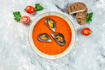 Wall Mural - tomato soup with mussels in a bowl on a light background, Restaurant menu, dieting, cookbook recipe top view