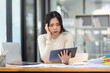 © SOMKID - Asian businesswoman are stressed and tired from work sitting at desk in the office, feeling sick at work, stress from work.