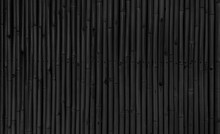 Architectural Dark Black Bamboo Wall For Japanese Mood Decoration, Interior Or Exterior Design. Black Bamboo Plank Fence Texture Used As Background With Blank Space For Design.