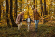 © bernardbodo - Mother, daughter and grandmother exploring the forest during autumn