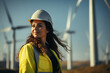 Black female Wind Turbine Technician is working on wind turbine farm.