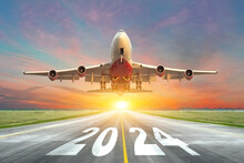 Inscription On The Runway 2024 Surface Of The Airport Road With Take Off Big Airplane Enjoy Travel Sunset Sunrise Dawn. Concept Of Travel In The New Year, Holidays.