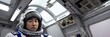 © useful pictures - Portrait of Asian man in space suit, astronaut floating inside the Space Station, surrounded high-tech equipment and instruments. Cosmonaut in space suit work on space station. Space research. Banner