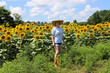 © Debbi Truax - Woman walking in sunflower field