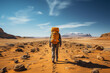 Rear View of a Hiker with Backpack Roaming in the Desert and Contemplating the Landscape